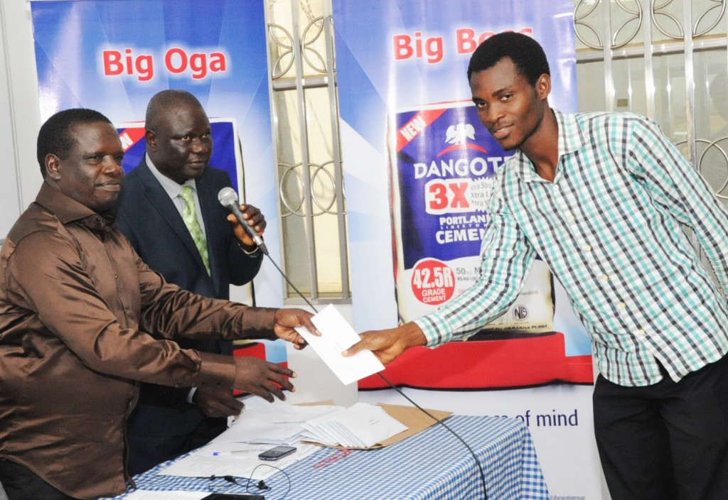 DSC_9858: L-R: DGM, Human Resources & Admin, Dangote Cement Ibese Plant, Mr. McDappa Ngo; DGM, External Relations, Dangote Cement Ibese, Mr. Joseph B. Alabi presenting scholarship award to Mr. Obadina Tolia of Ekiti State University at Dangote Cement PLC presentation of scholarship award to Ibese Indigines 