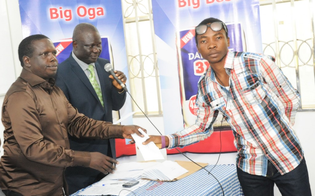 DSC_9859: L-R: DGM, Human Resources & Admin, Dangote Cement Ibese Plant, Mr. McDappa Ngo; DGM, External Relations, Dangote Cement Ibese, Mr. Joseph B. Alabi presenting scholarship award to Mr. Gbadamosi Ayodele of Adekunle Ajasin University, Akungba, Ondo State at Dangote Cement PLC presentation of scholarship award to Ibese Indigines 