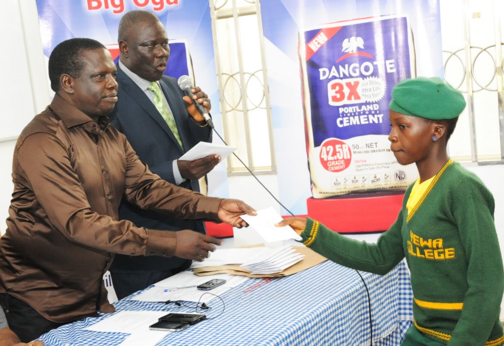 DSC_9861: L-R: DGM, Human Resources & Admin, Dangote Cement Ibese Plant, Mr. McDappa Ngo; DGM, External Relations, Dangote Cement Ibese, Mr. Joseph B. Alabi presenting scholarship award to Miss Usman Yetunde Iyabode of Yewa Egbado College, Ilaro, Ogun State at Dangote Cement PLC presentation of scholarship award to Ibese Indigines 